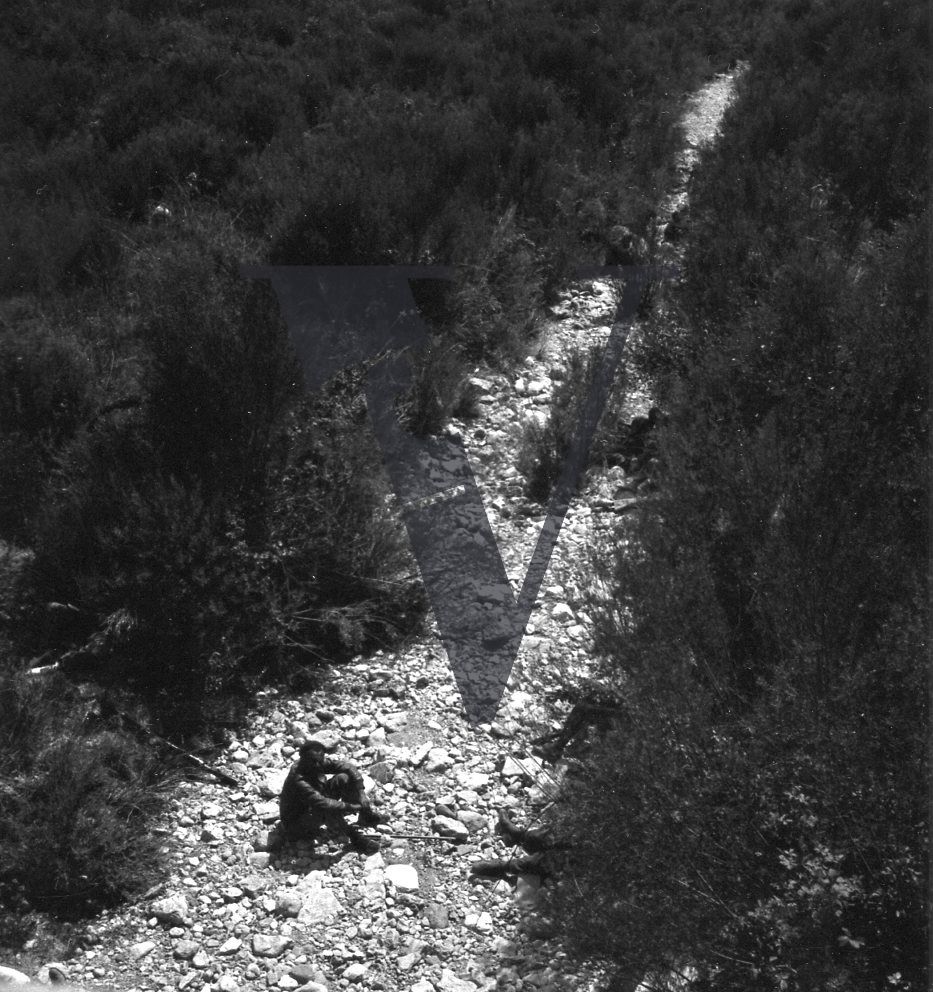 Spain, man seated in canyon, long shot.