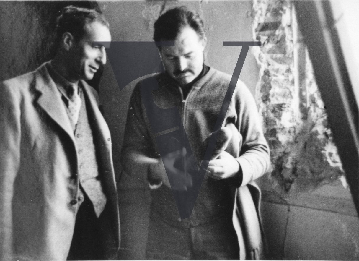 Spain, Madrid, Hotel Florida, Herbert Matthews and Ernest Hemingway inspecting a shell.