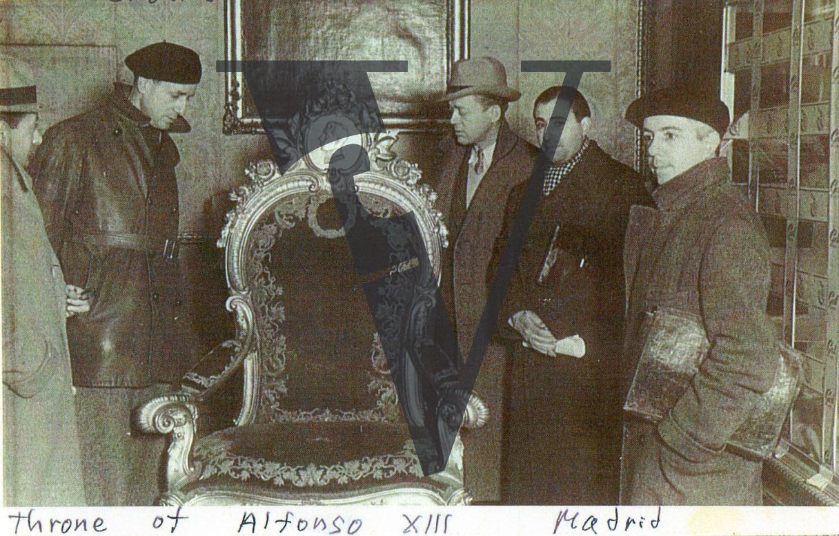 Spain, Madrid, Herbert Matthews with colleagues inspecting the throne of Alfonso XIII, portrait.
