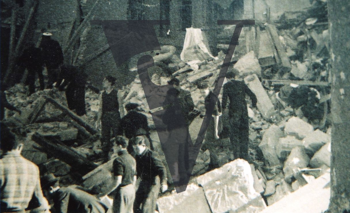 Spain, Madrid, group of people, rubble, destroyed building.