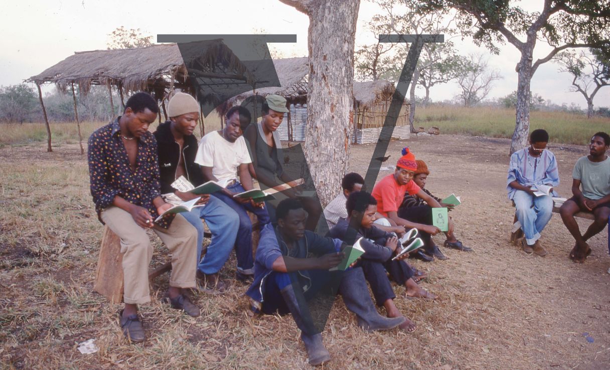 Tanzania, PAC, Pan Africanist Congress camp, men reading pamphlets.