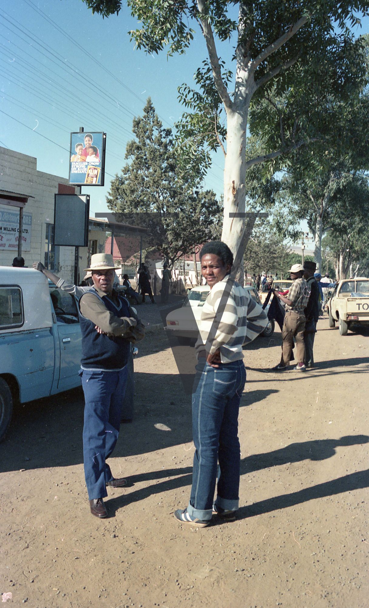 South Africa, Transkei, street scene, two men, vehicles.