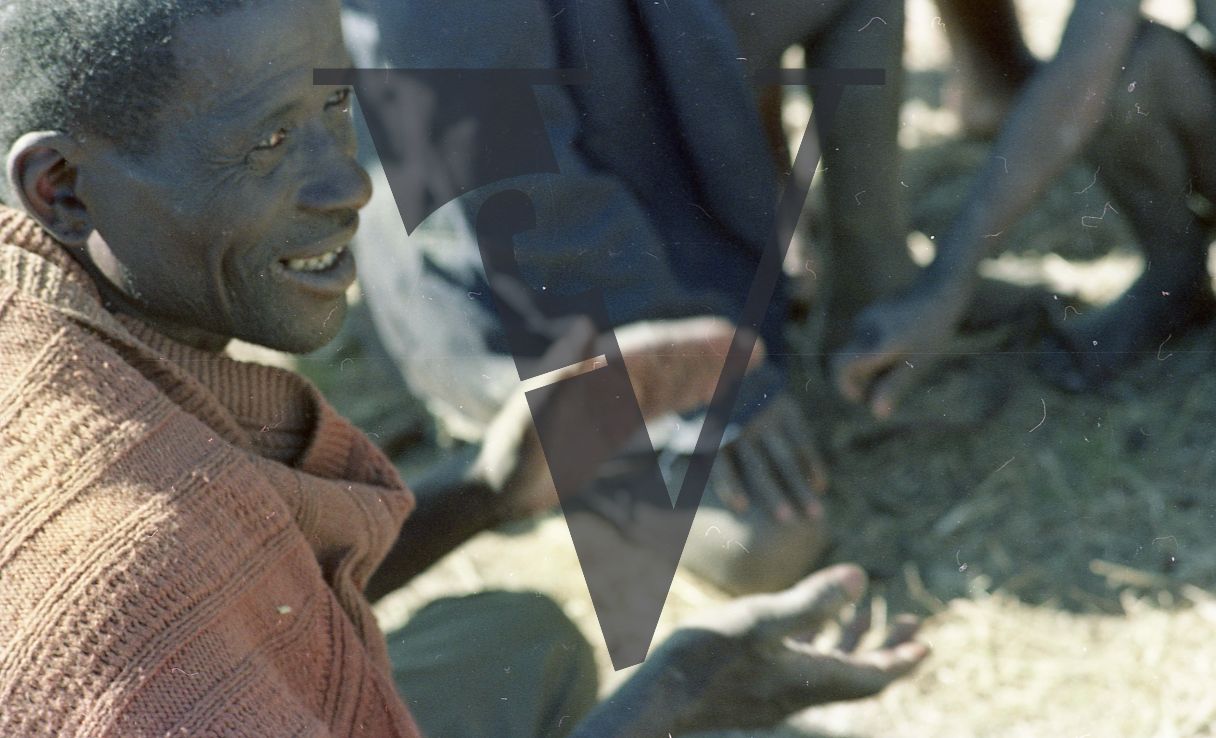 South Africa, Transkei, man sitting, clapping.