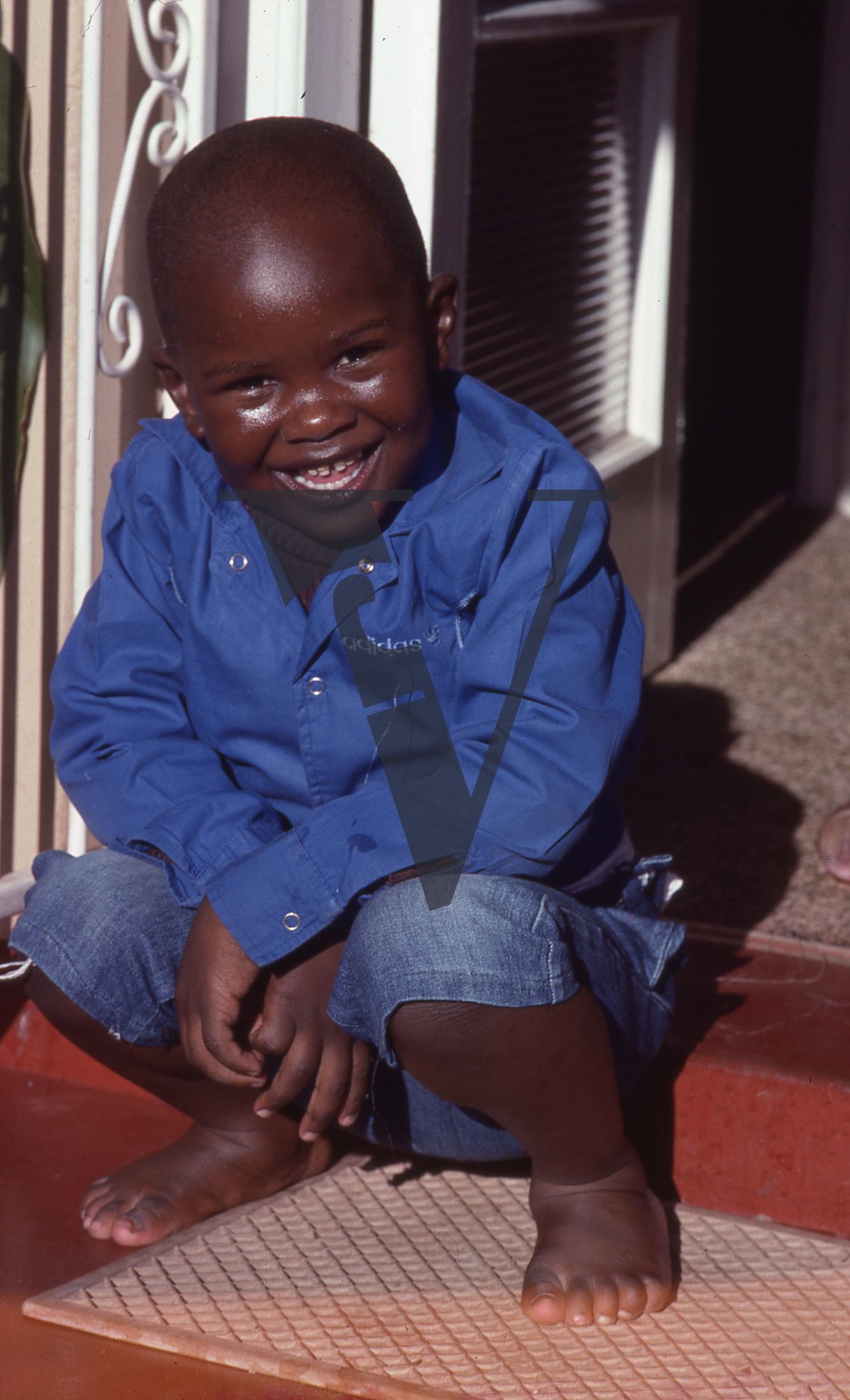 South Africa, Transkei, Fikile Bam’s son, smiling, squatting, portrait, Yu Chi Chan Club.