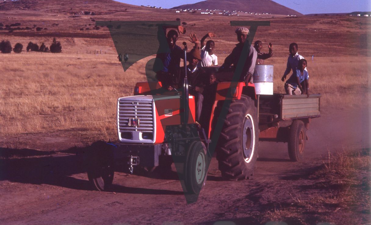 South Africa, Transkei, landscape, men on tractor, smiling, portrait, wide shot.