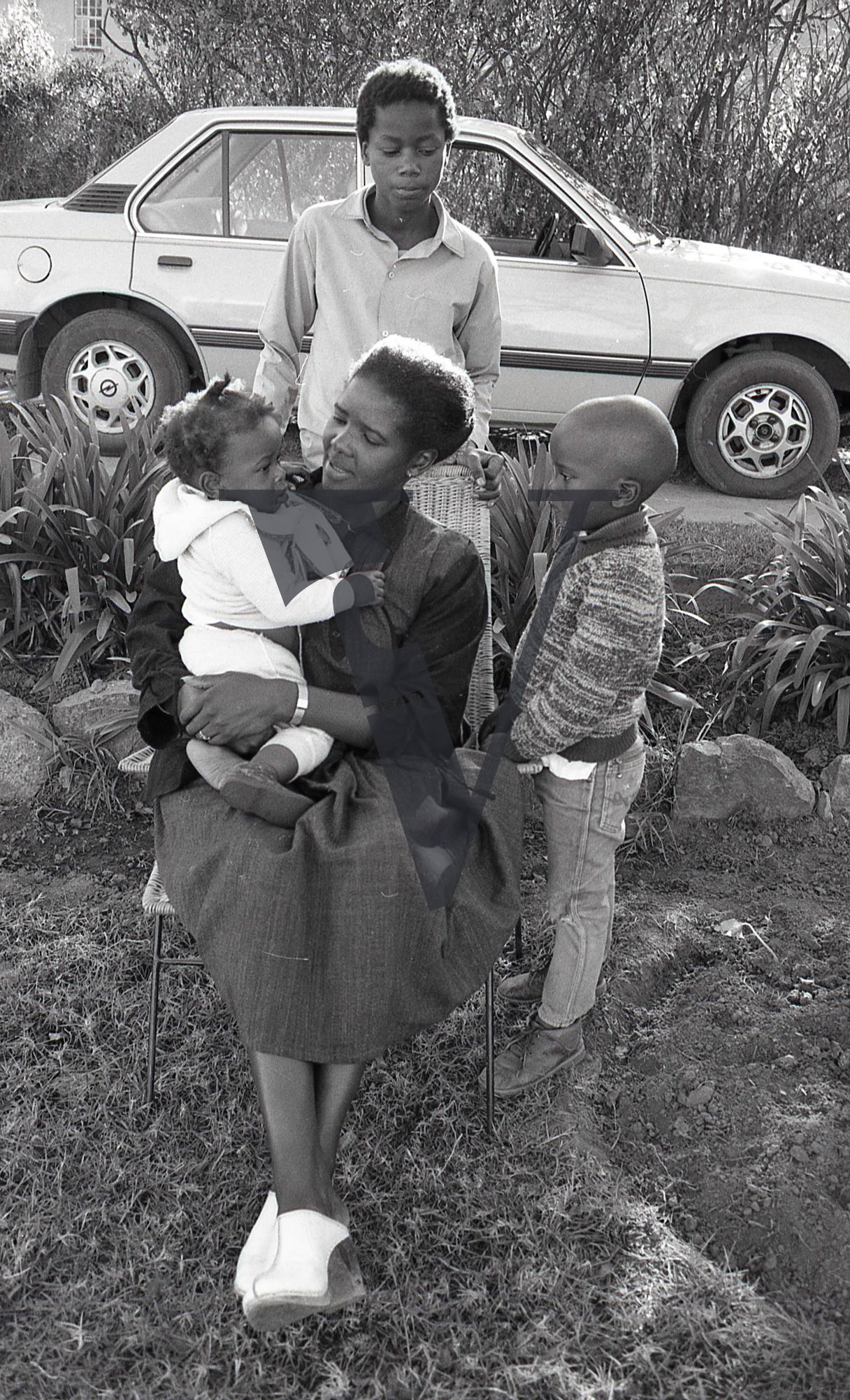 South Africa, Transkei, family, mother with infant, young boys, car, portrait, full shop.
