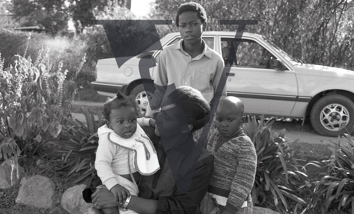 South Africa, Transkei, family, mother with infant, young boys, car, portrait, mid-shop.