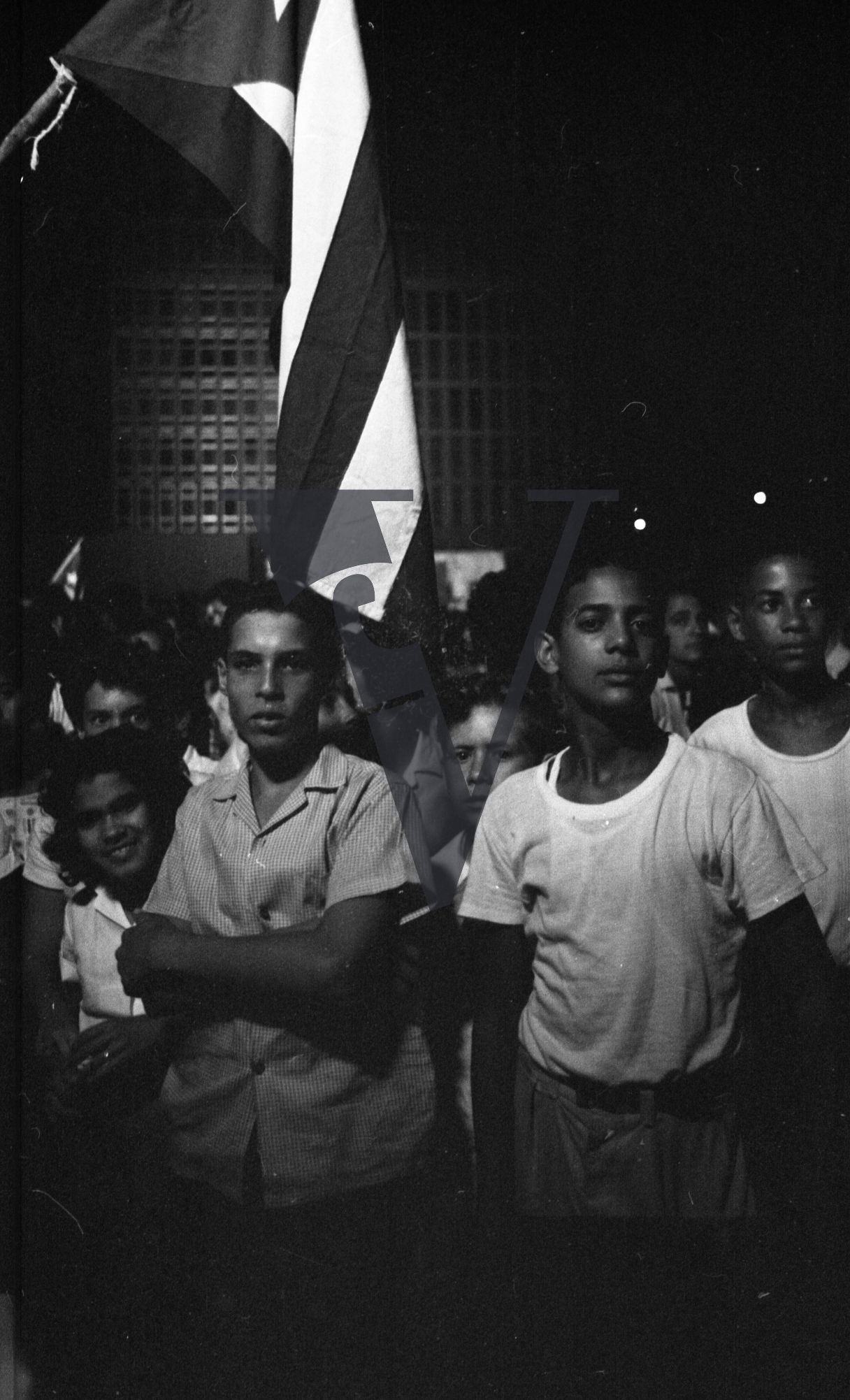 Cuba, Havana Youth Rally, youths with flags.