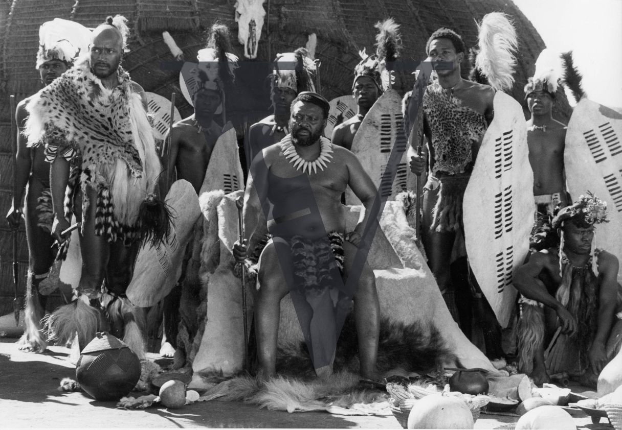 South Africa, ’Zulu Dawn’ film, production still, cast members, Simon Sabela seated, Cetshwayo, full shot.