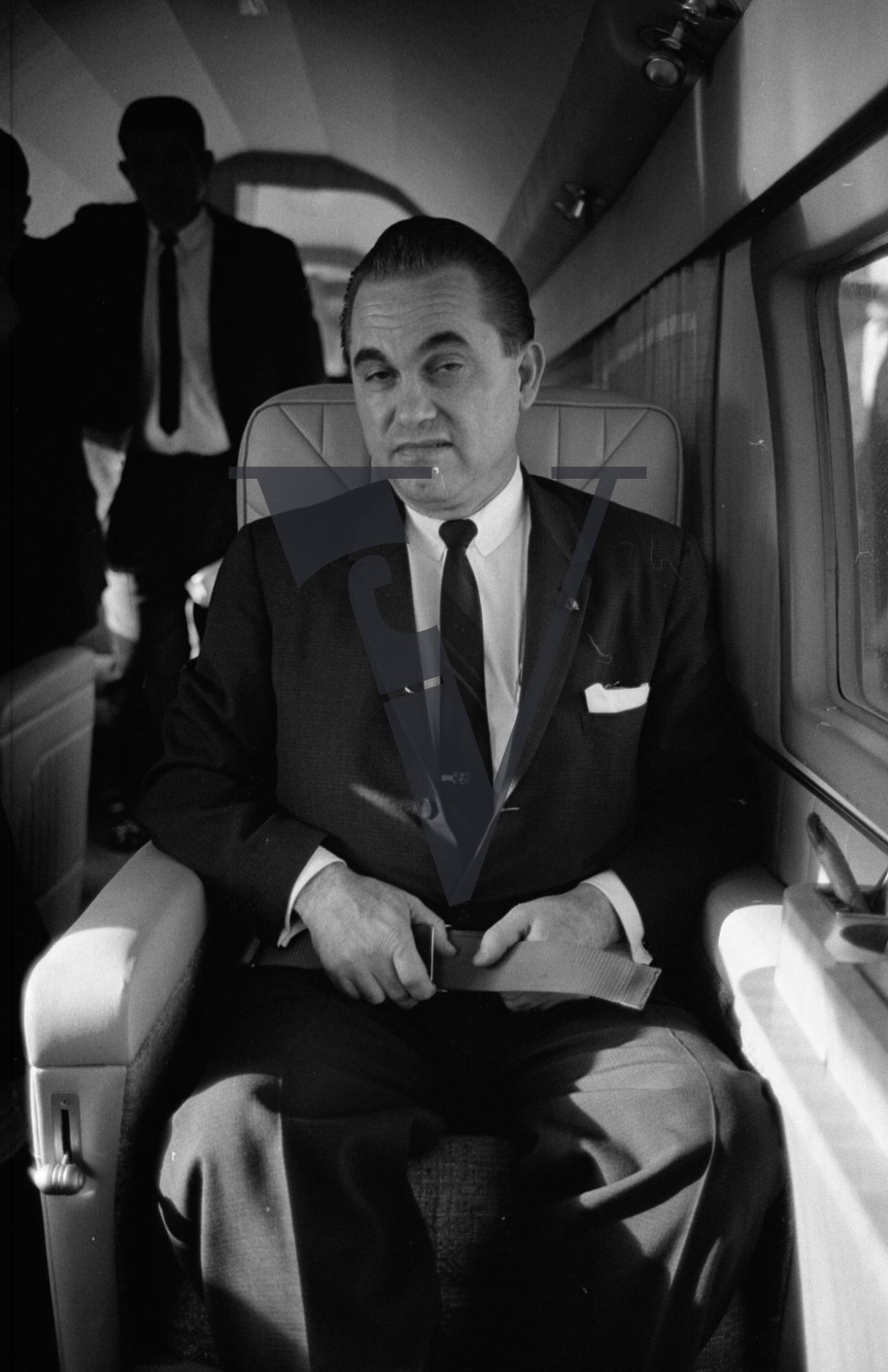 Governor George Wallace, on board plane, portrait, blinking.