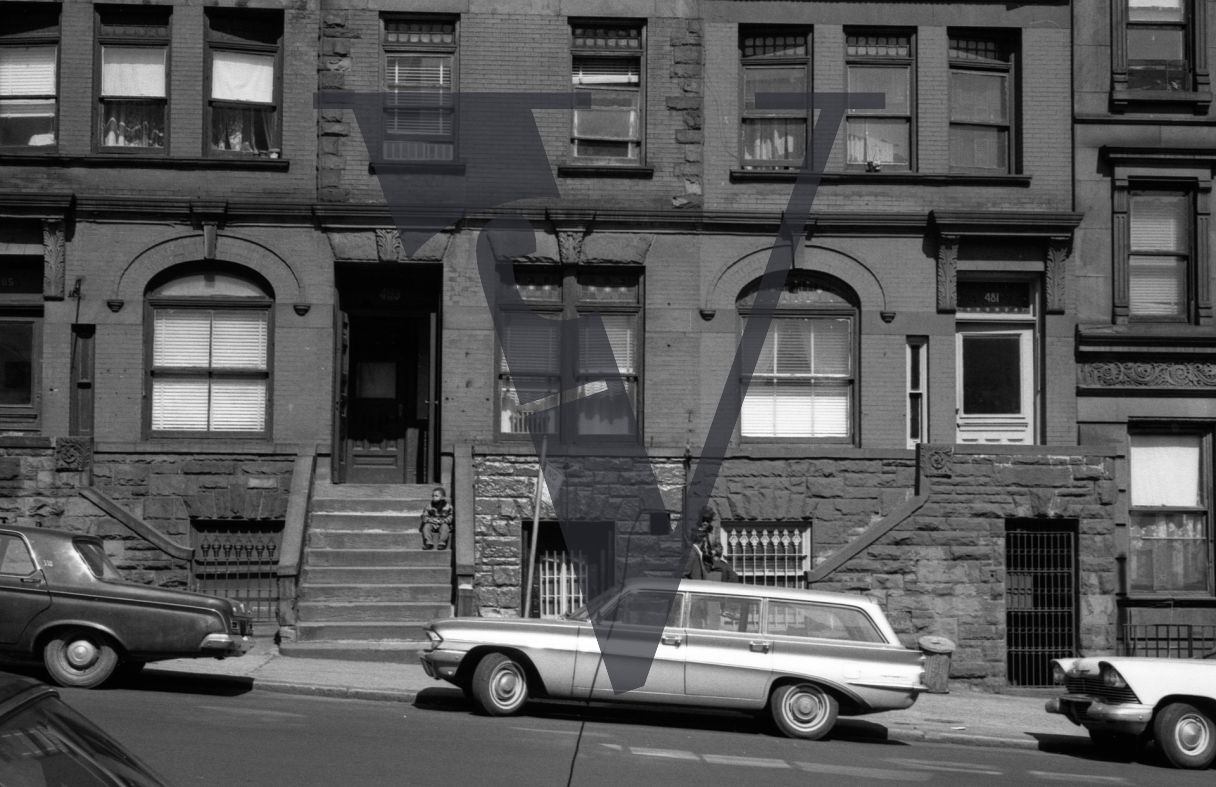 Harlem, New York City, street scene, cars, brownstone.