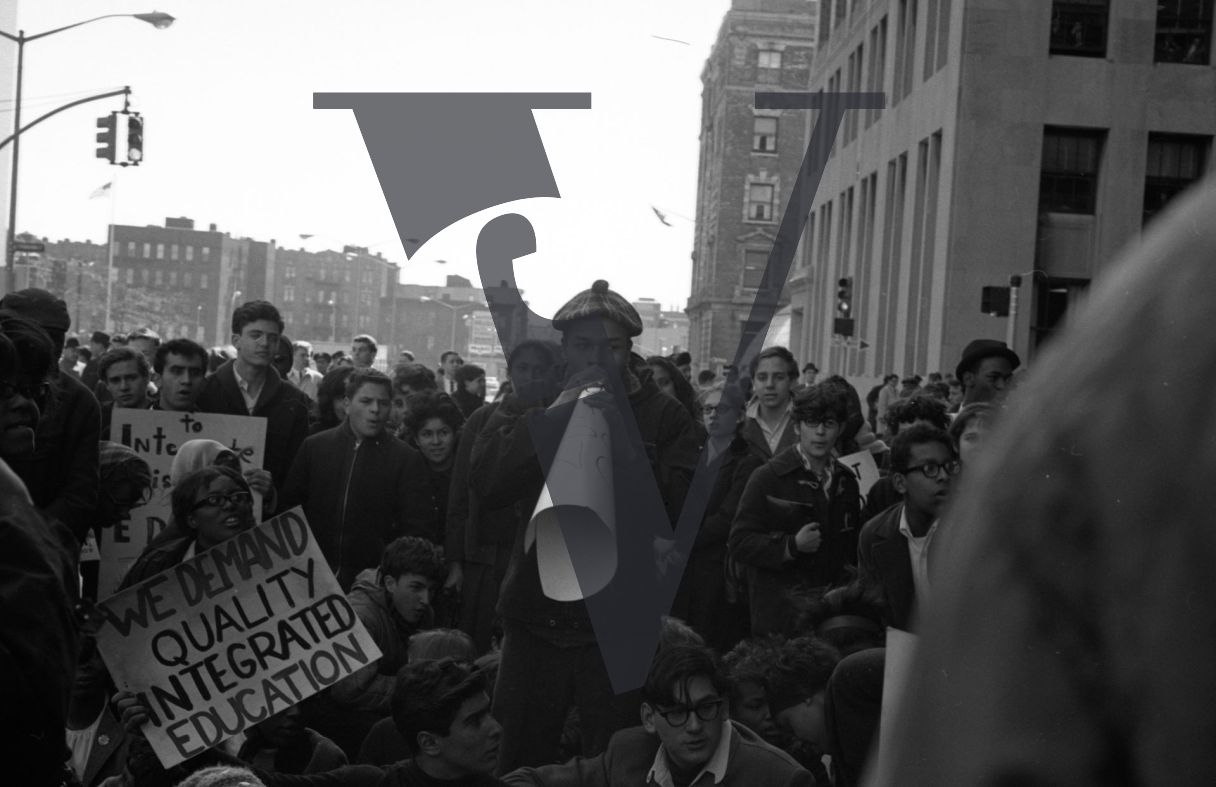 New York protest demo, man with loudspeaker, We Demand Quality Integrated Education sign.