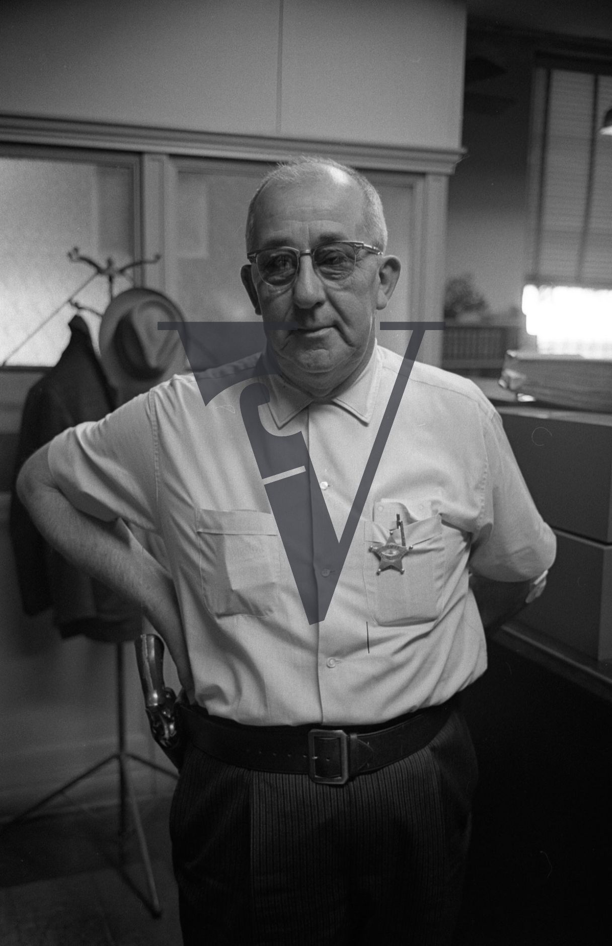 Leflore County Sheriff George Smith, portrait, gun and badge.