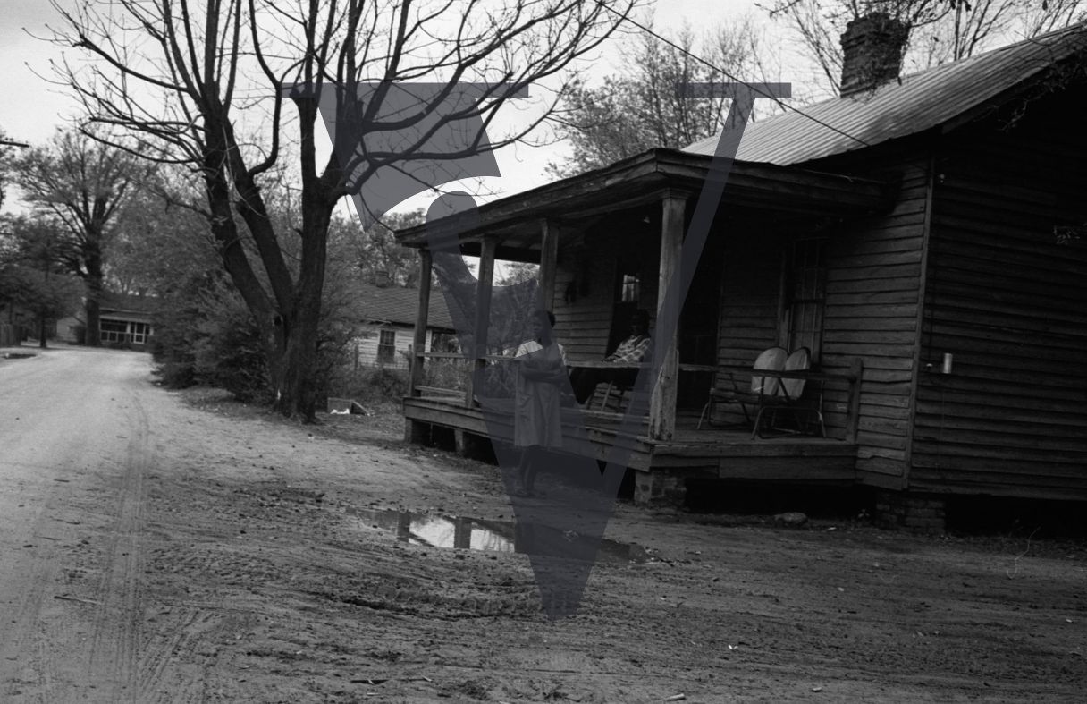 Sumter, South Carolina, rural housing, woman walks outside.