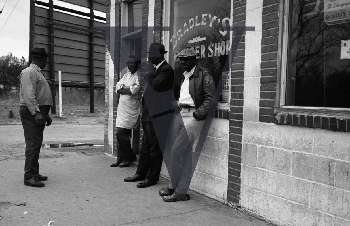 Sumter, South Carolina, streetscene, men congregate outside Bradley's Barber Shop.