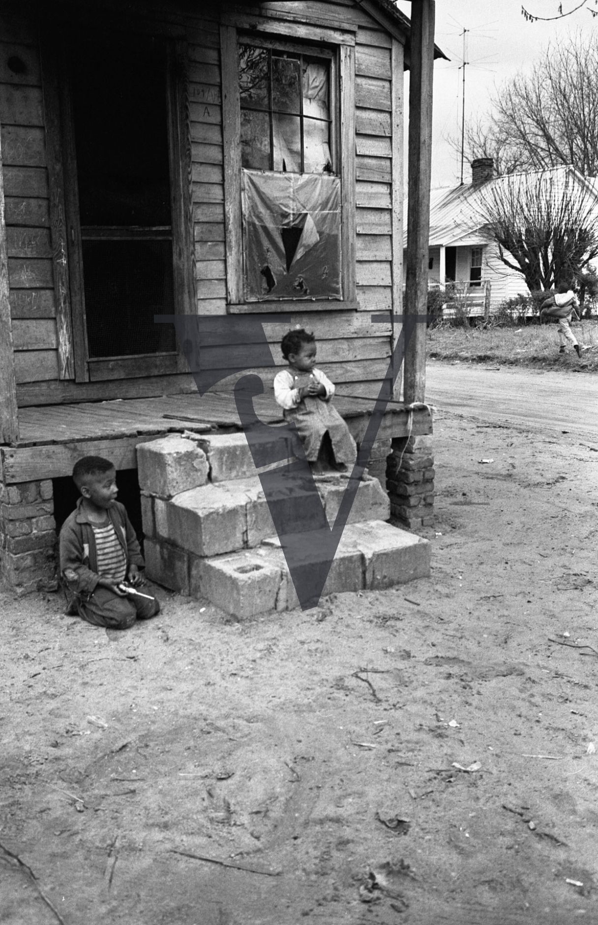 Sumter, South Carolina, rural street scene, winter, housing, children on house front.