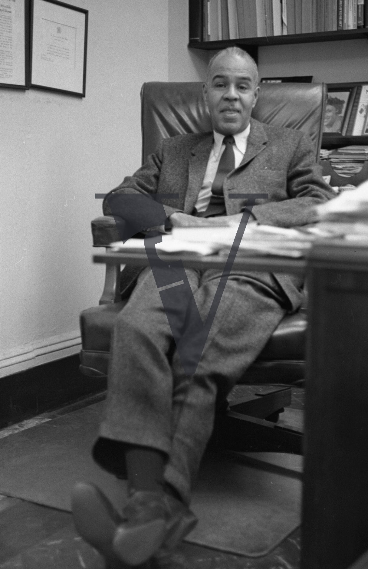 Roy Wilkins, leader, National Association for the Advancement of Colored People, NAACP, portrait at desk.