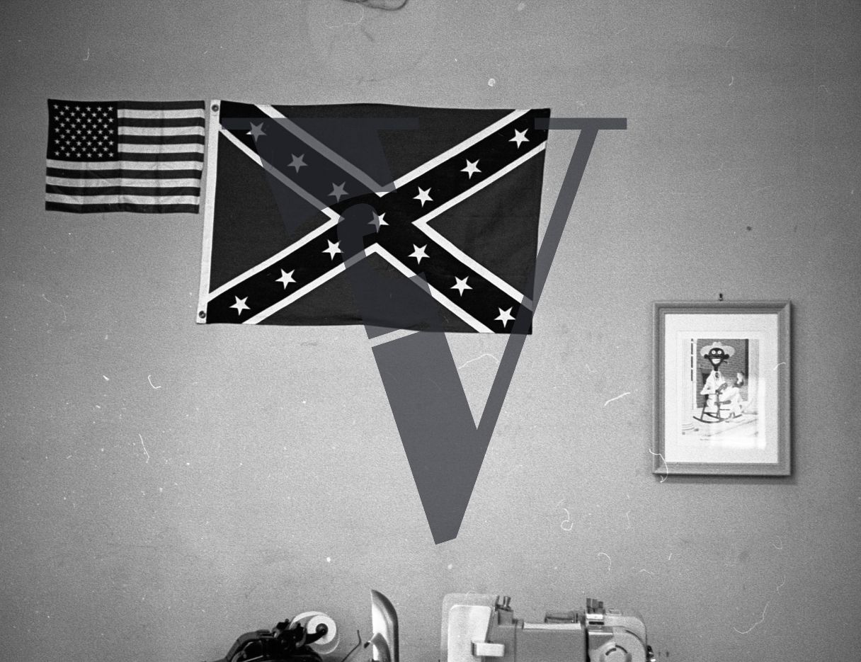 Racist signs and posters, close-up, Confederate flag.